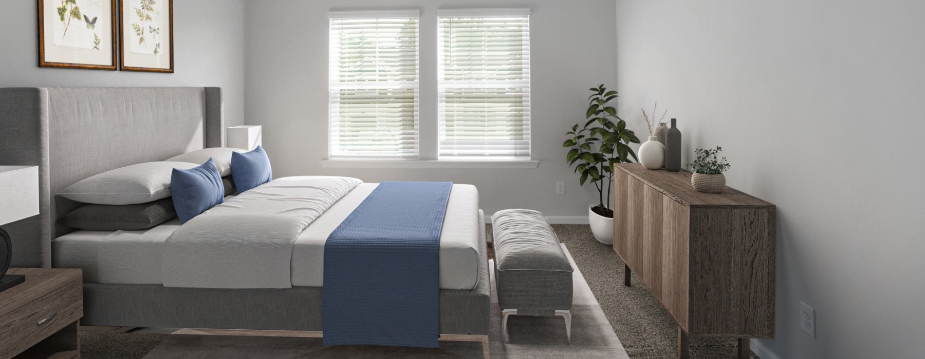 Savannah, GA, Townhomes - Haven at the Highlands - Bedroom With Ceiling Fan, Two Windows With White Blinds, And Wood Dresser With Plant Decor.