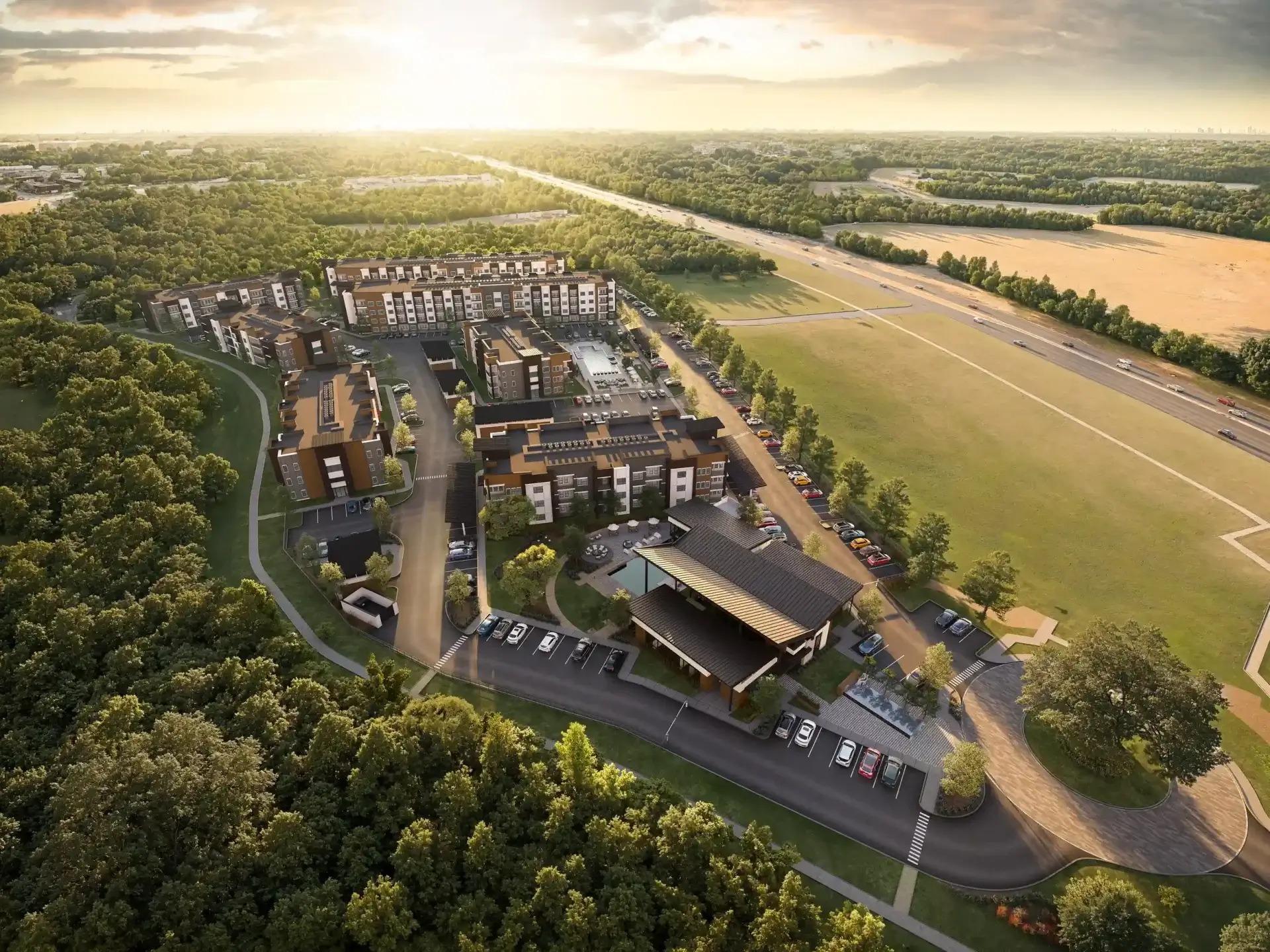 Aerial view of Rasha at Audubon apartments in Magnolia, TX, featuring luxury buildings, green spaces, and the resort-style pool.