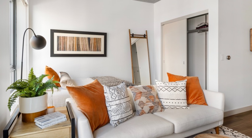 a living room with a couch and a mirror