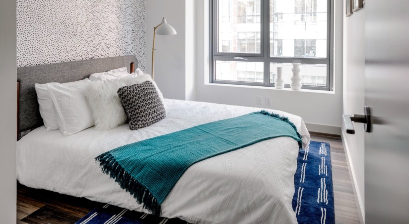 a bedroom with a bed and a window