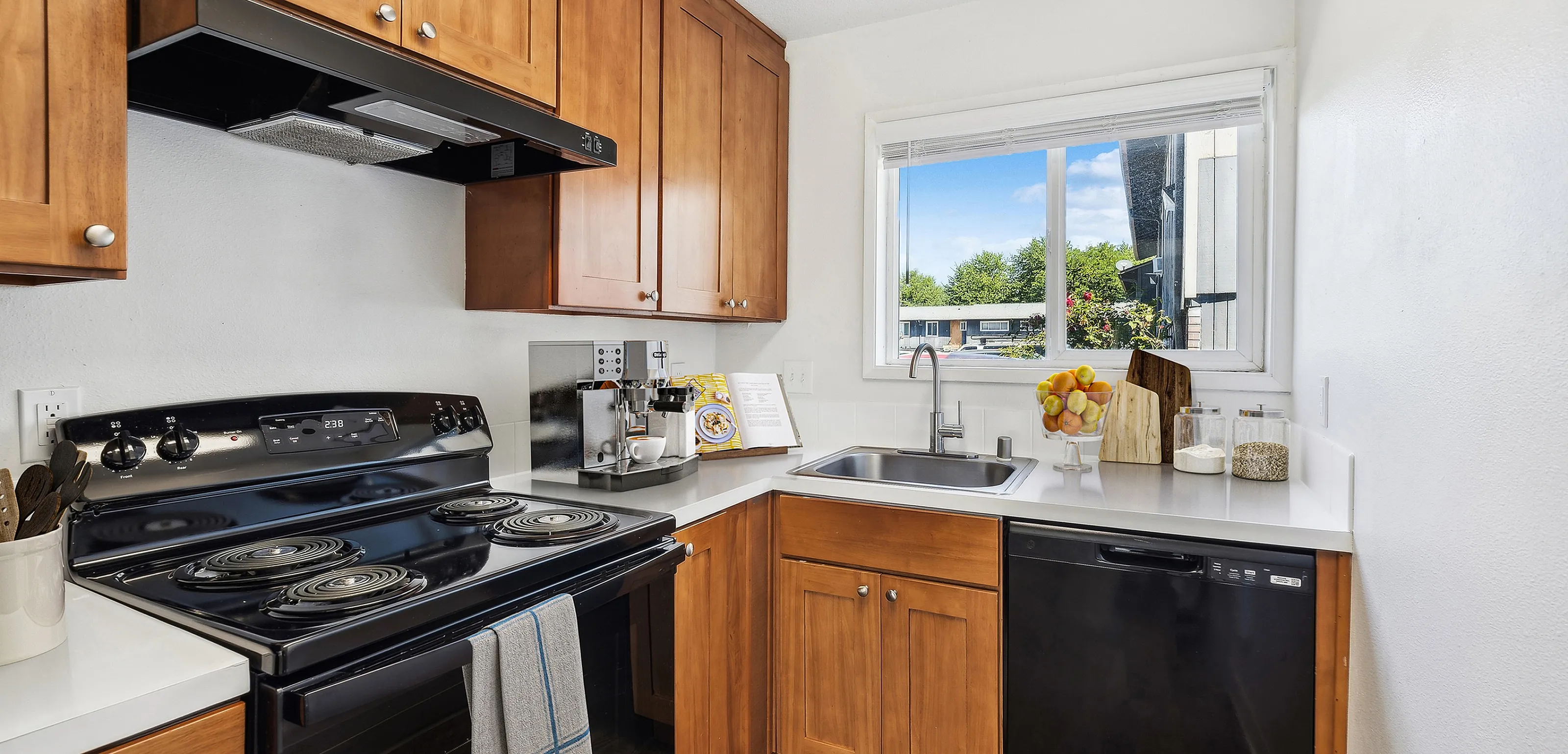 Bright and inviting kitchen with wooden cabinets, modern appliances, and a window view.