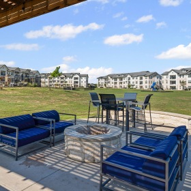 Outdoor fire pit and seating at 4 Corners apartments in Frisco. 