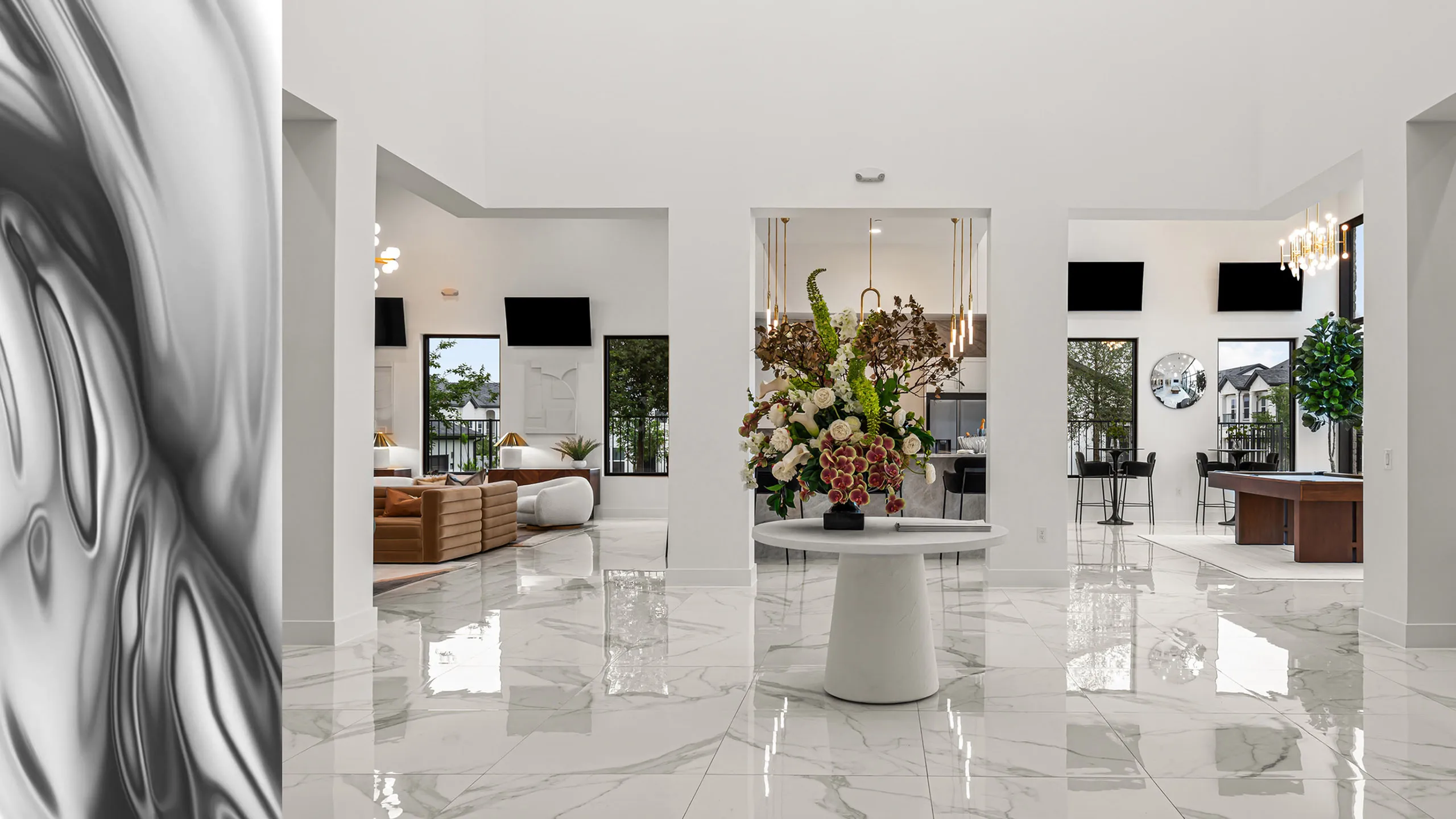 Luxurious open-concept space with marble flooring, elegant decor, and plush seating, ideal for stylish entertaining and relaxation.