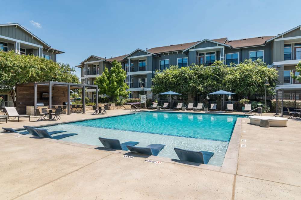 Lounge chairs in the swimming pool at Landing at Double Creek in Austin, Texas