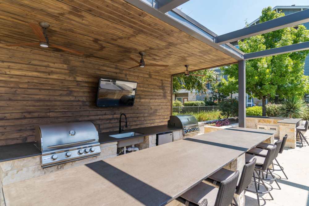 Covered grilling area by the pool at Landing at Double Creek in Austin, Texas