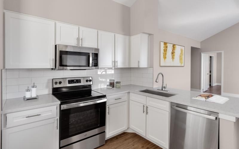 a kitchen with white cabinets