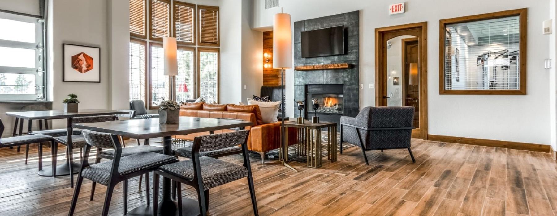 a clubroom with a fireplace and chairs