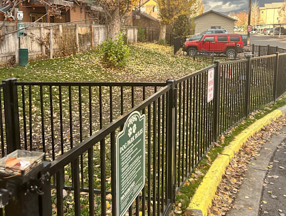 A sign on a fence reads "Parking Hours".