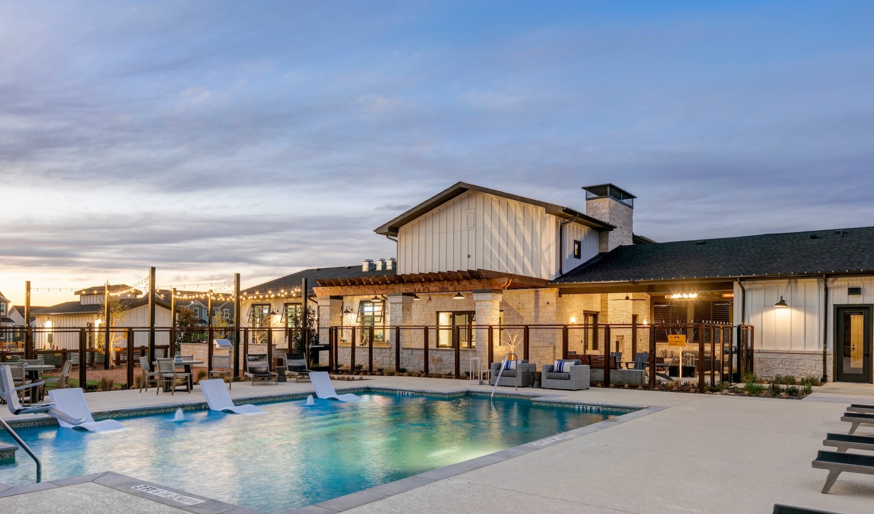 A luxe resort inspired pool with outdoor lounge