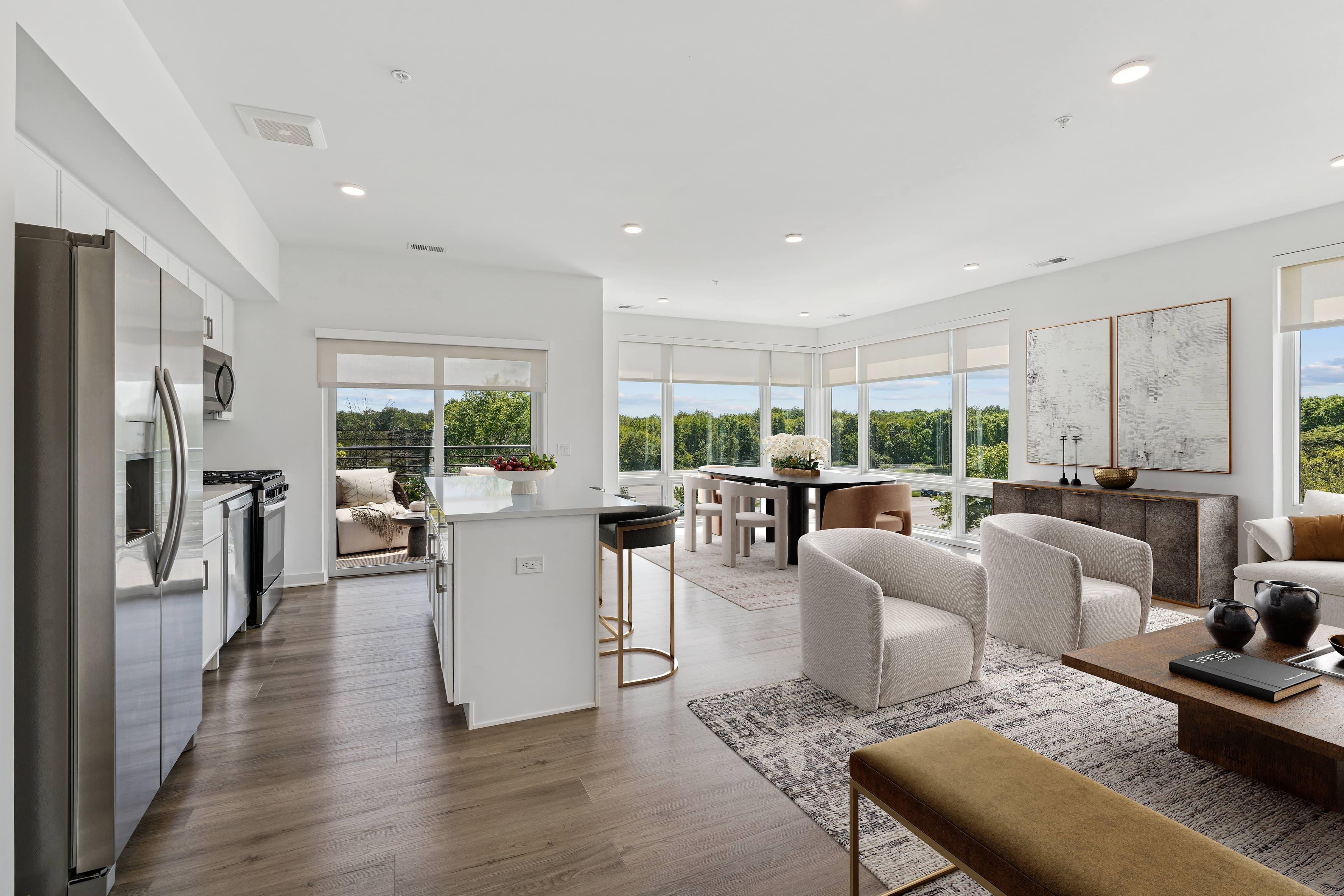 Spacious living room at Livana East Hanover featuring an open kitchen and dining area in New Jersey.