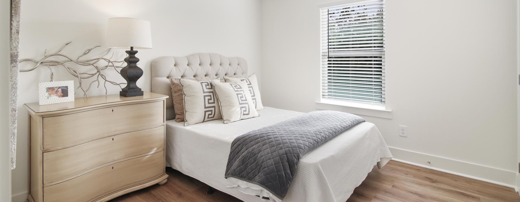 a bedroom with a bed and a lamp