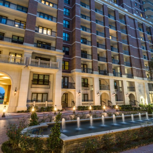 a building with a car parked in front  and a fountain