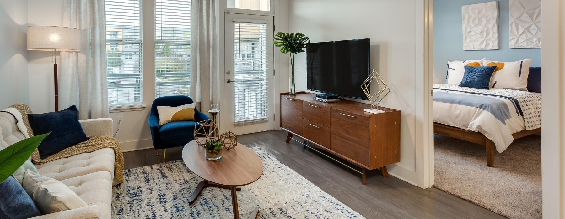a living room with a bed and a tv