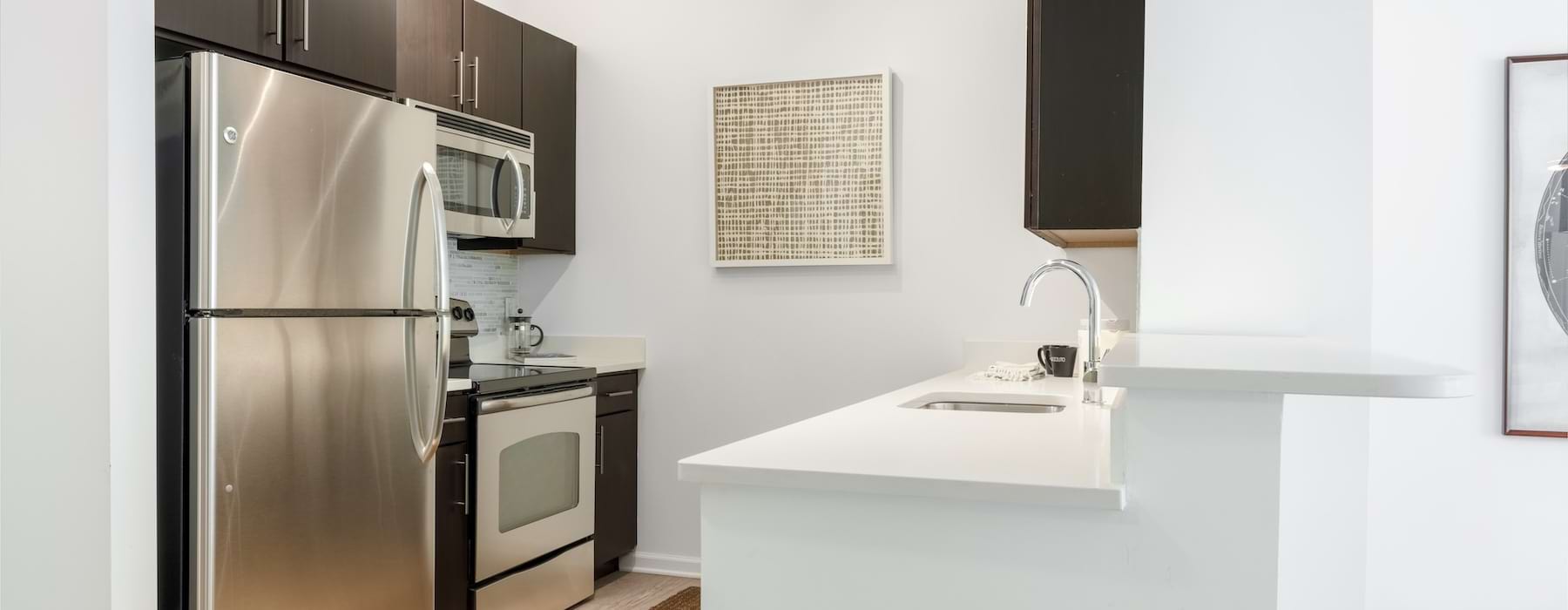 Model kitchen with counter sink in a 1 bedroom apartment in Washington DC at 14W.