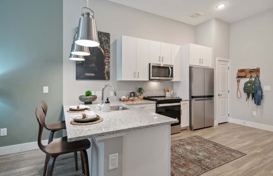 Apartment kitchen with an island and stainless-steel appliances at 101 Depot in Smyrna, Tennessee