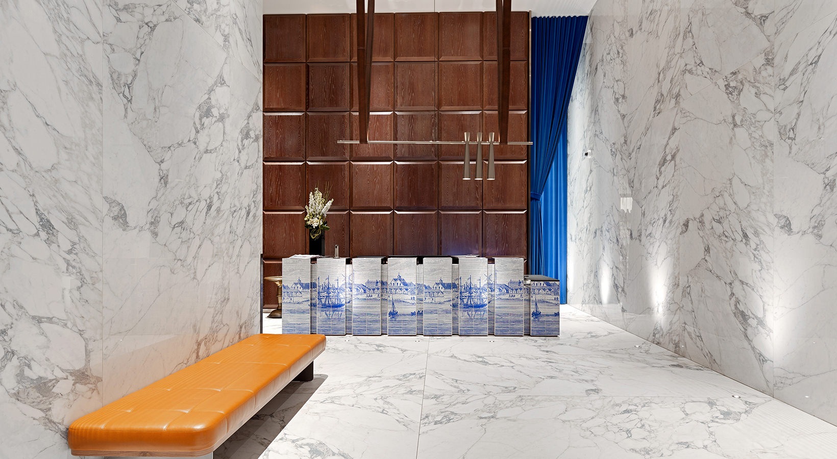 Sleek marble lobby at 19 Dutch featuring modern wood paneling and bold boutique-style design in Lower Manhattan.