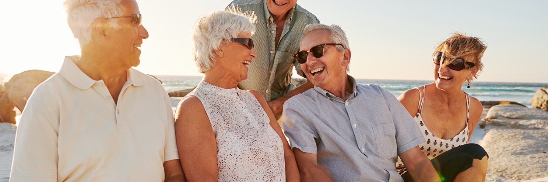 a group of friends laughing on the beach