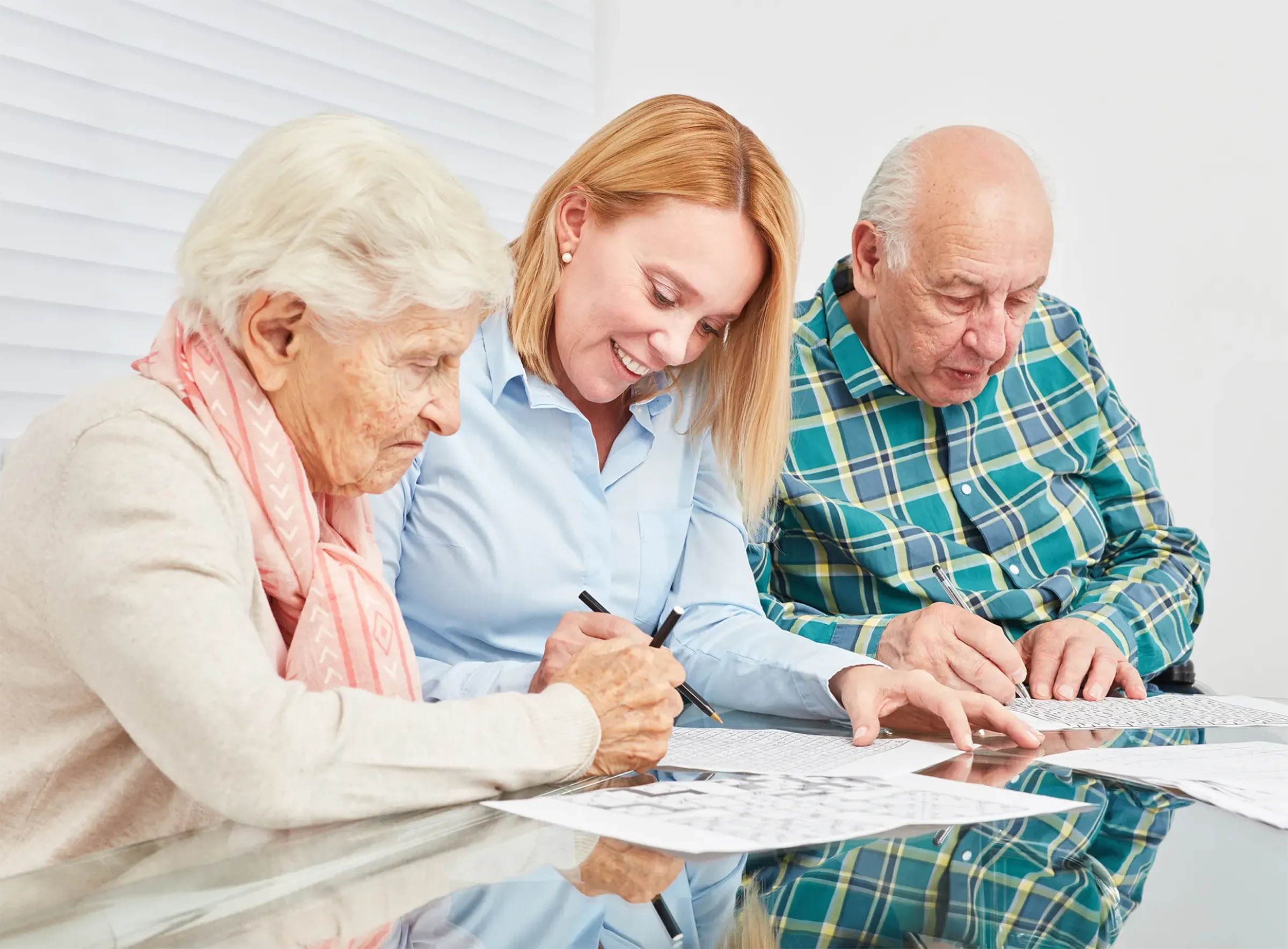 young woman with senior couple signing paperwork