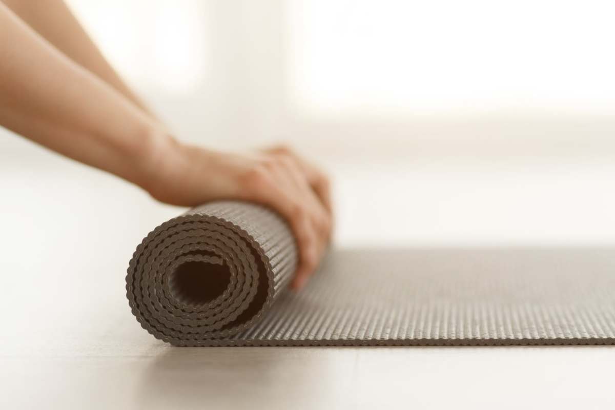 Yoga mat being rolled up in a studio at The Exchange at Spring Hill Station in Vienna, Virginia
