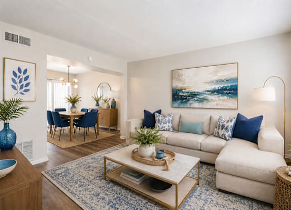 A living room with a blue vase on a coffee table.