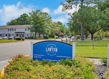 A blue sign with the name "Lawton" on it in white letters.