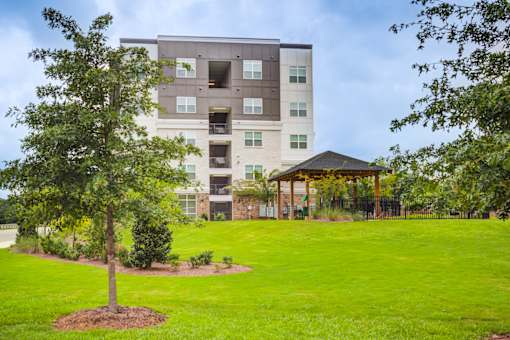 Beautiful landscaped grounds and outdoor green space at Townes at Clarkston Centre, offering pet-friendly 1, 2, and 3 bedroom apartments in Clarkston, Georgia.