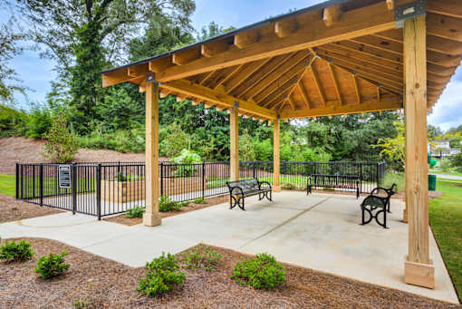 Covered outdoor pavilion with picnic seating and landscaped gathering space at Townes at Clarkston Centre, a pet-friendly apartment community in Clarkston, GA.