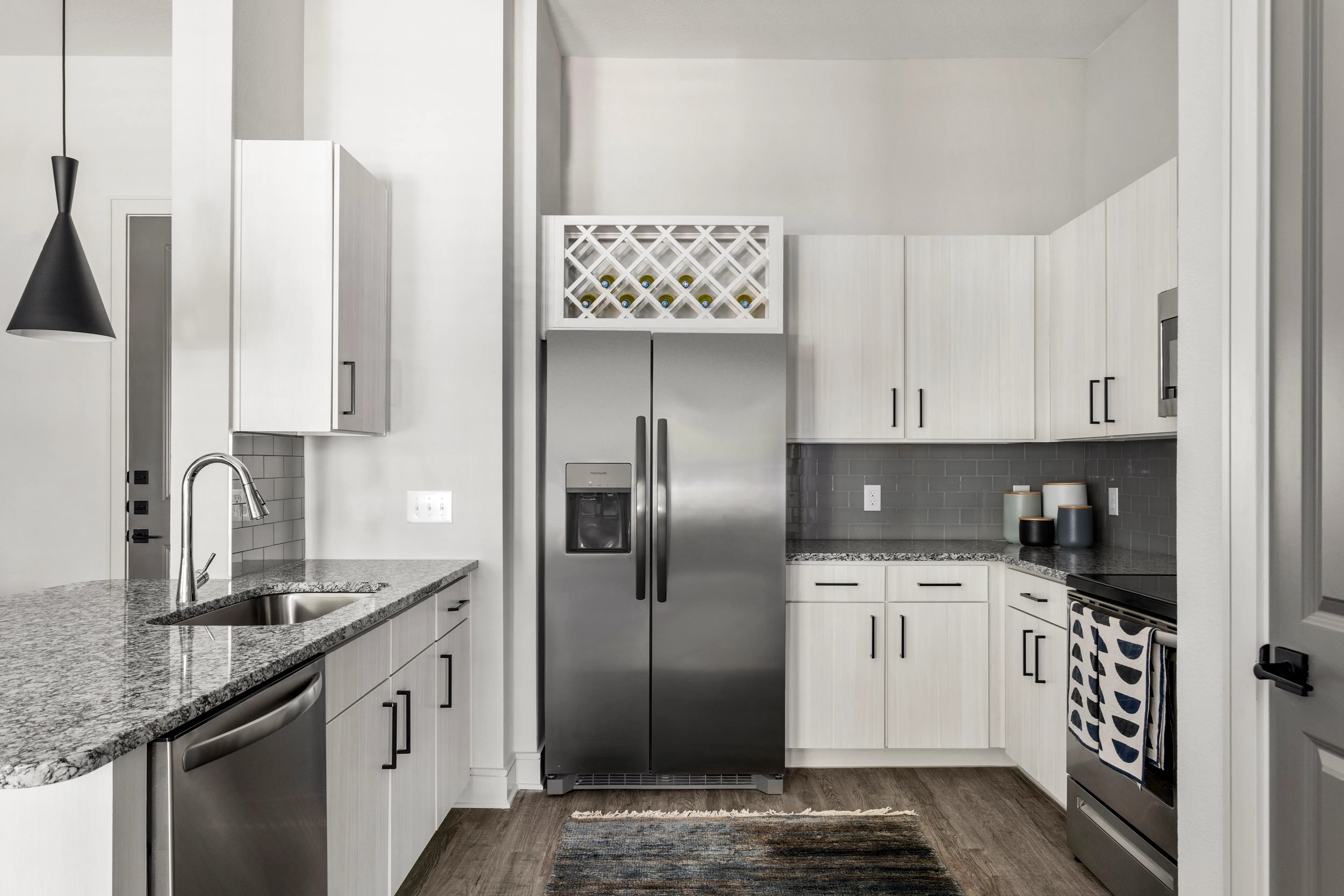 Linz at the Station - Picture of kitchen with Custom Contemporary Cabinetry with Wine Racks