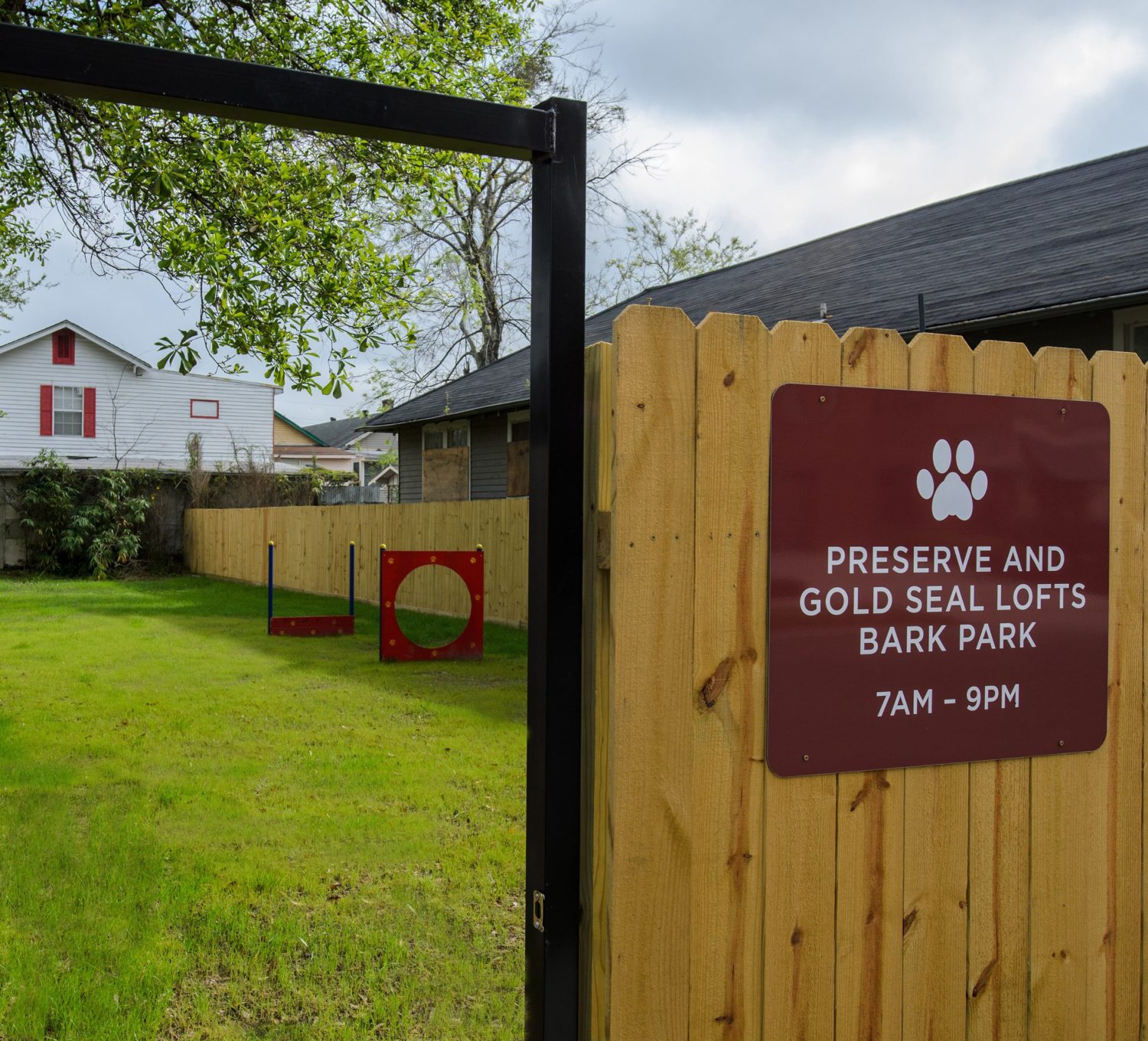 Preserve and Gold Seal Lofts Bark Park sign displaying hours 7AM - 9PM