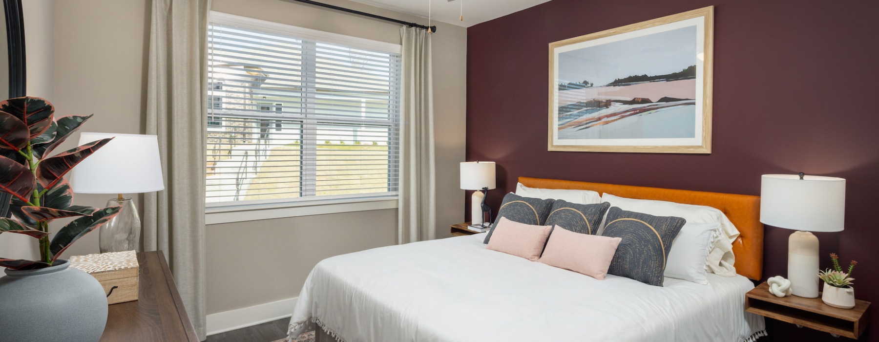 bedroom with purple accent wall, bed and end tables