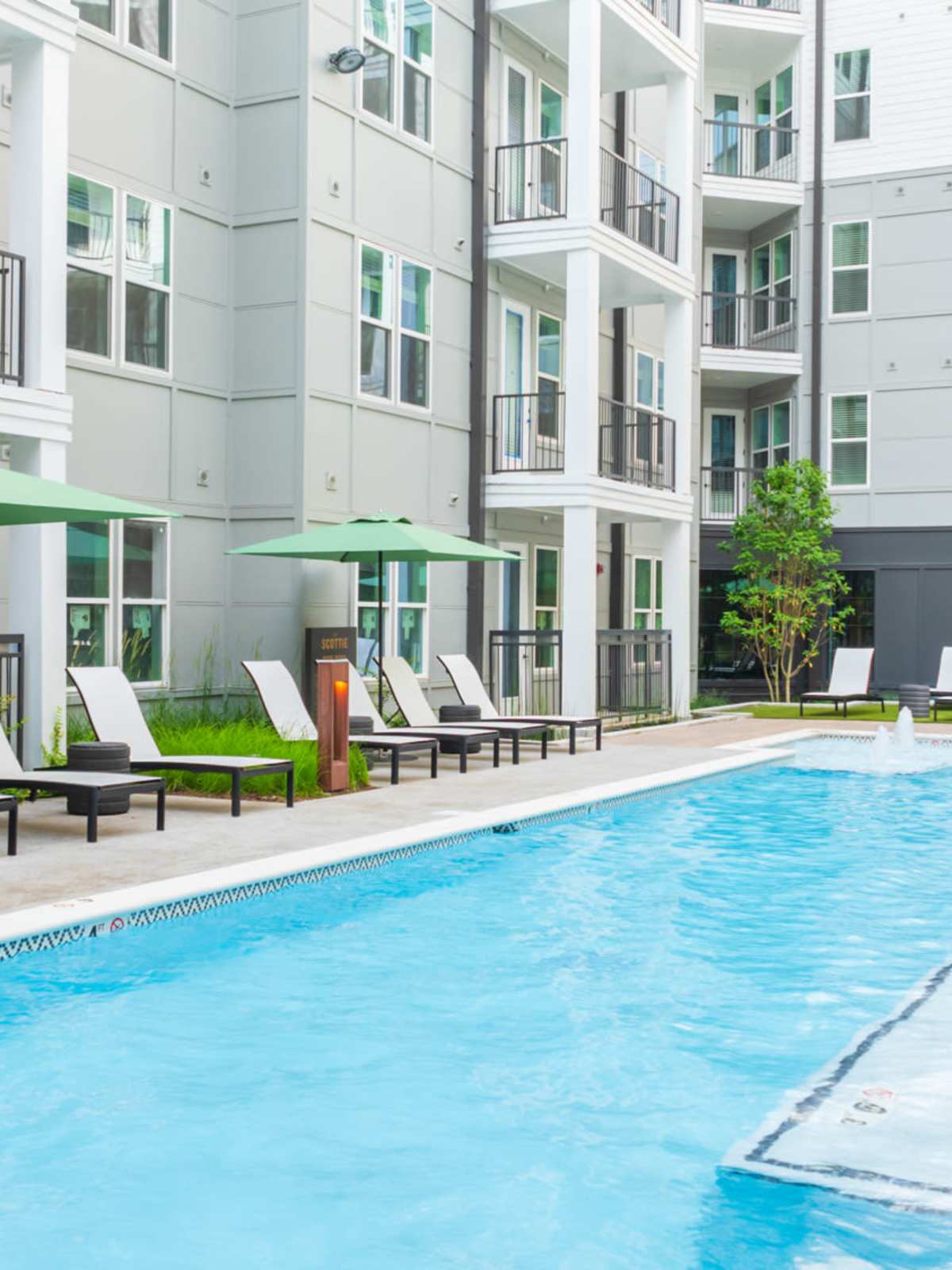 Resort-style swimming pool with lounge chairs at The Scottie in Nashville, Tennessee