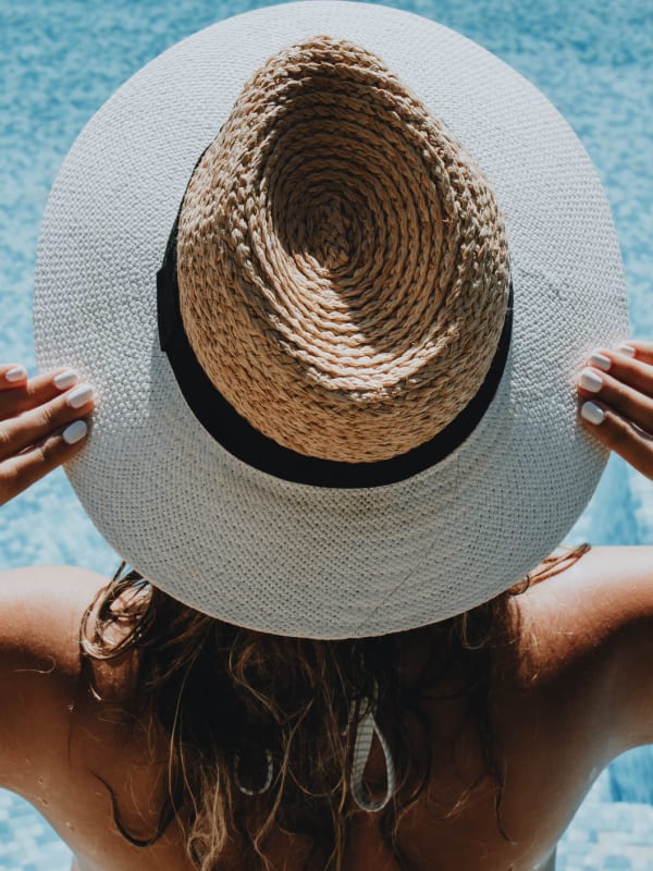 Woman with a sun hat on at the pool at The Kendry in Charlotte, North Carolina