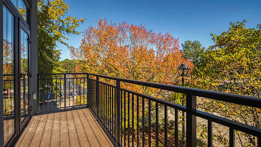 A balcony with a black railing and a lamp post at Aviator Lofts, Newport News, VA 23602