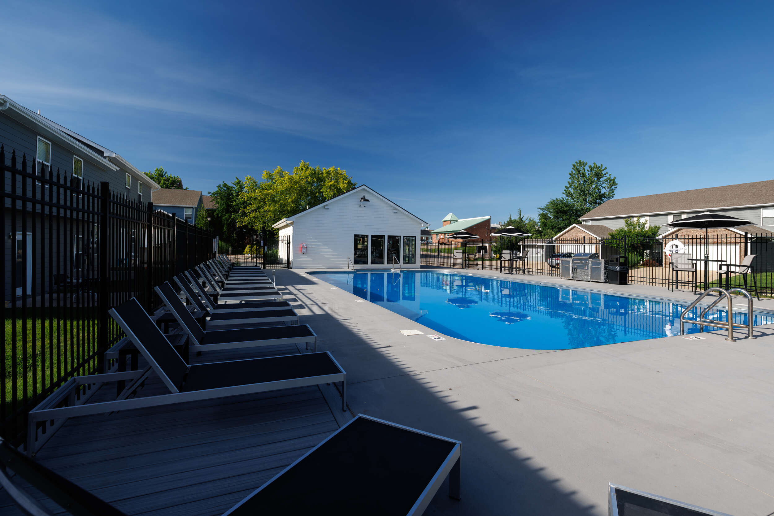 sparkling pool with sundeck seating the row apartment homes near mizzou