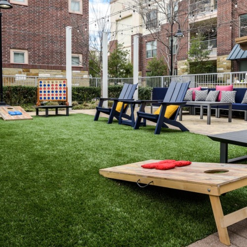 a group of picnic tables in a park with High Line in the background