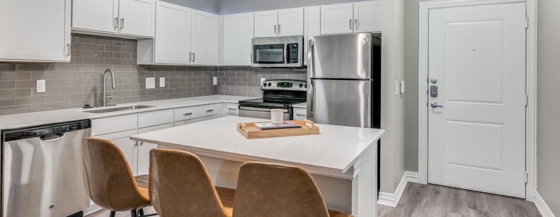 a kitchen with a table and chairs