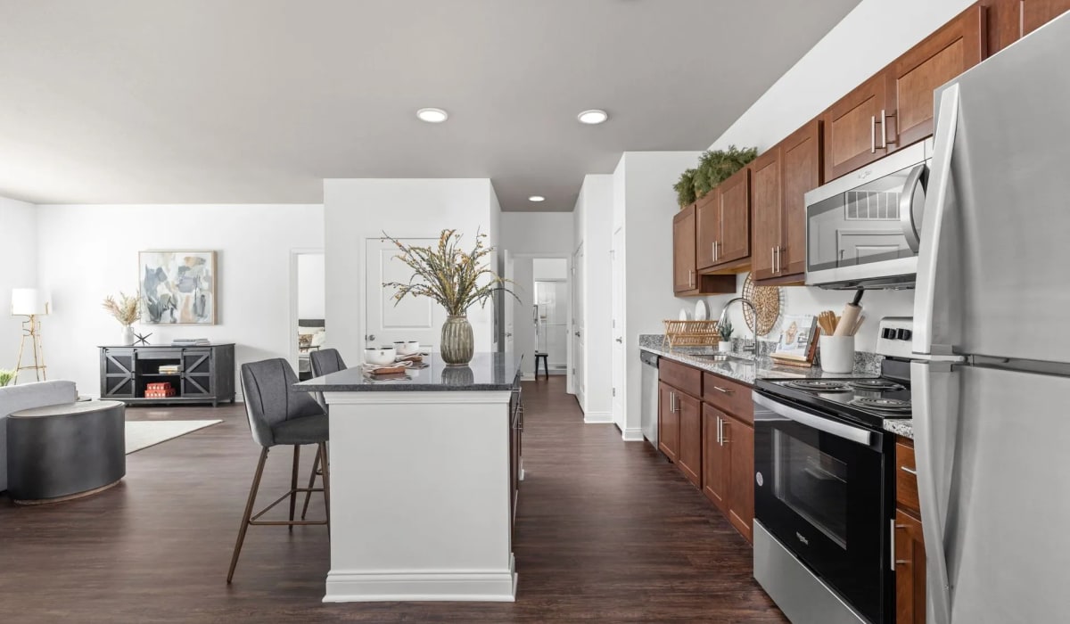 Kitchen, island with granite countertops, refrigerator and oven at Union Club Apartments in Fort Wayne, Indiana
