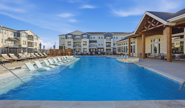 a swimming pool with lounge chairs