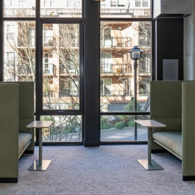a clubroom with a glass door and bookshelves