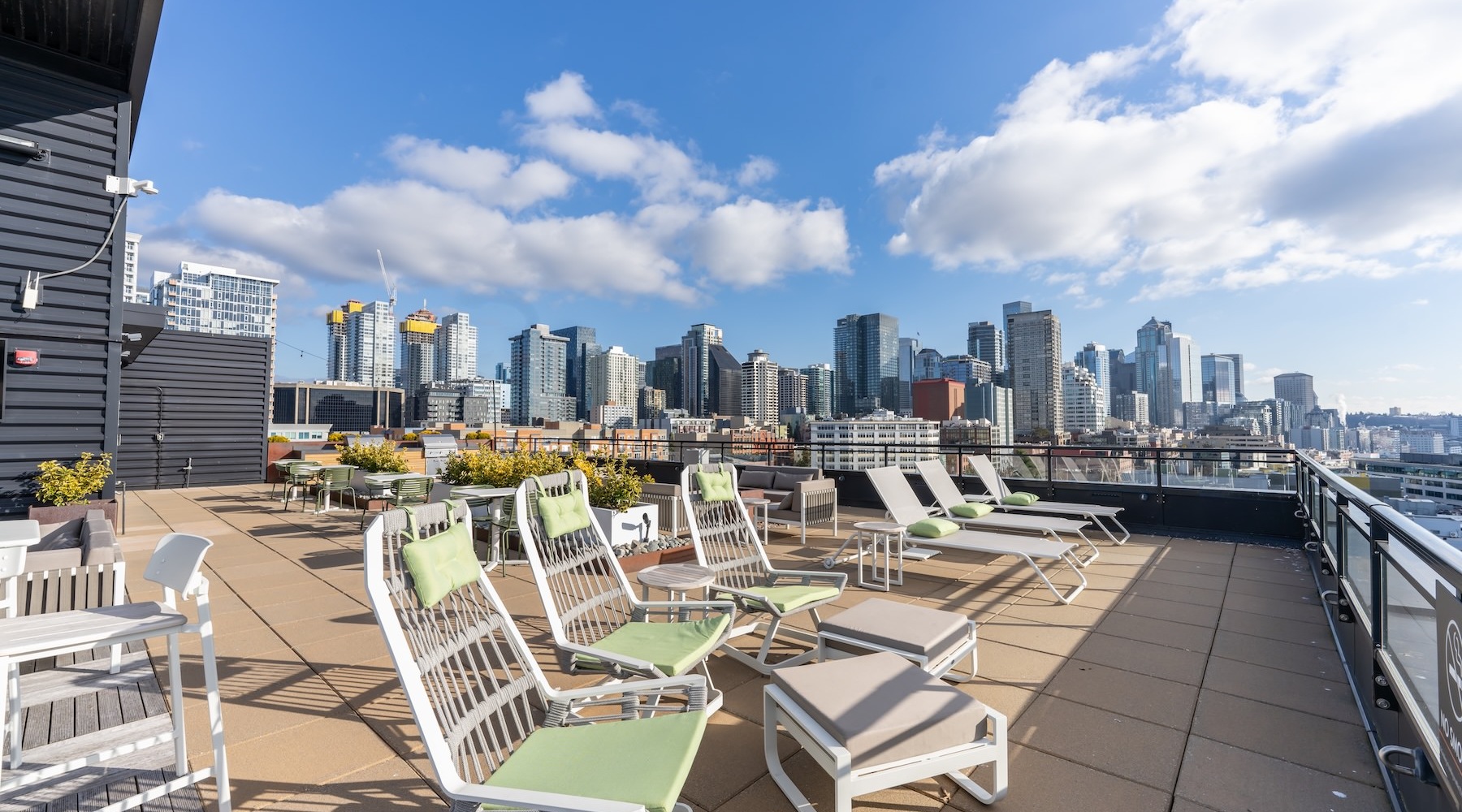 a rooftop area with lounge chairs