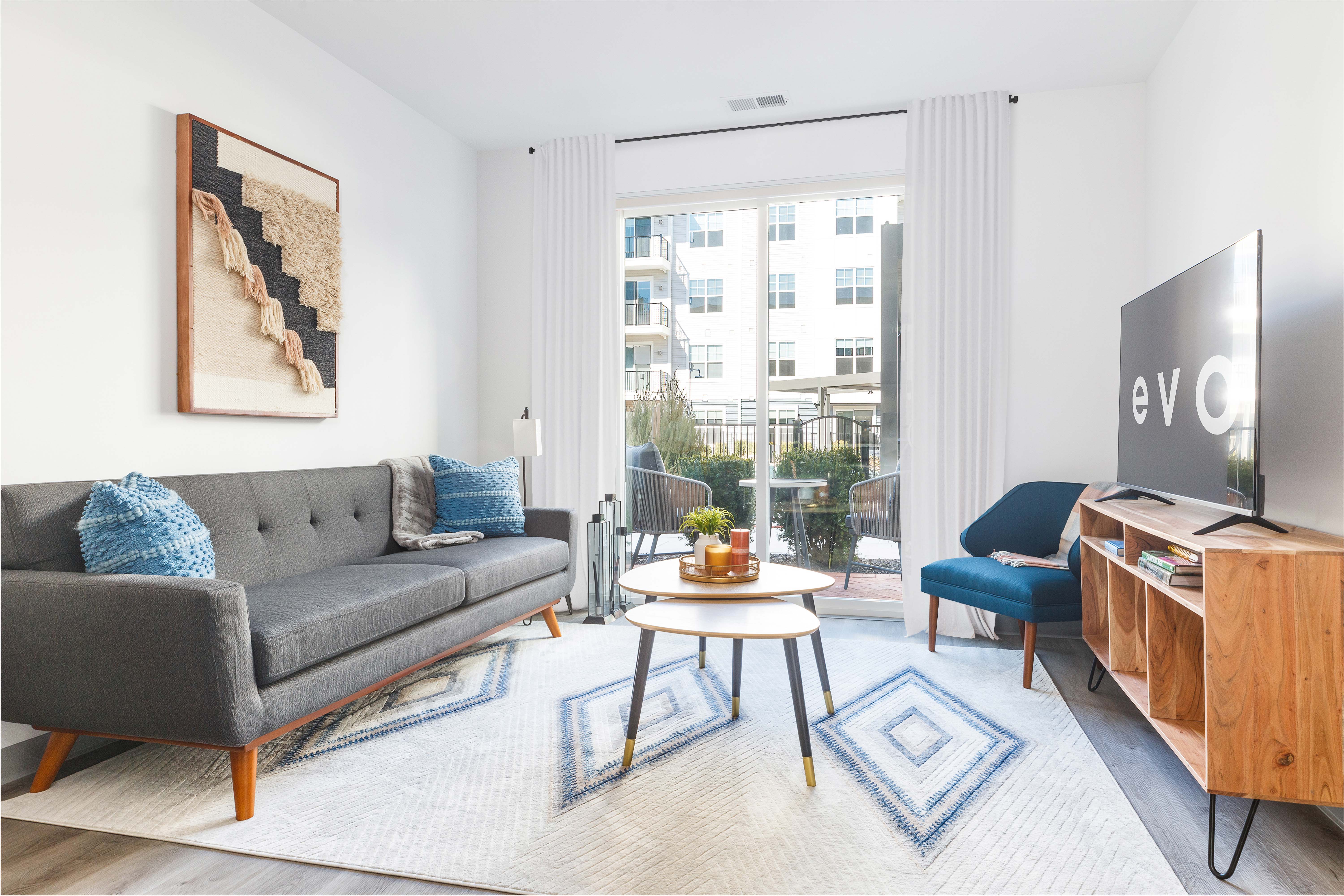 Apartments in Englewood-EVO-Living Room with Large Glass Sliding Door and Hardwood Style Flooring