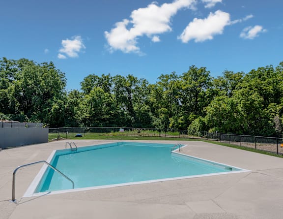 our resort style swimming pool is next to our building with lounge chairs