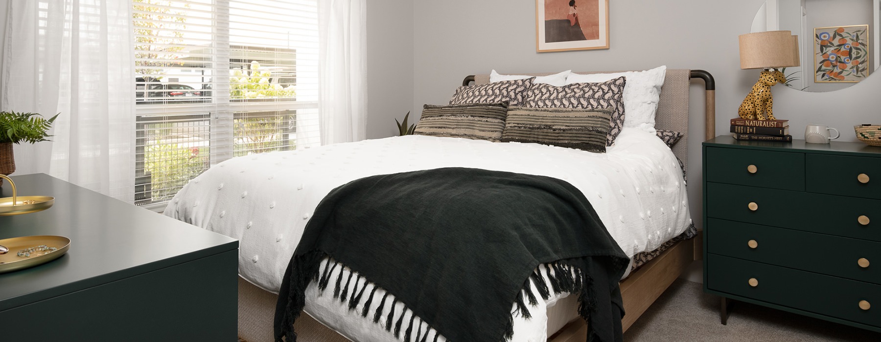 Spacious and well lit bedroom with plush carpet and large windows