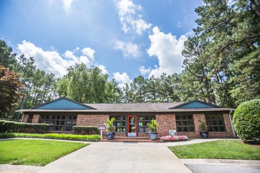 Clubhouse exterior at Remington Place Apartments in Raleigh, NC with welcoming community entrance