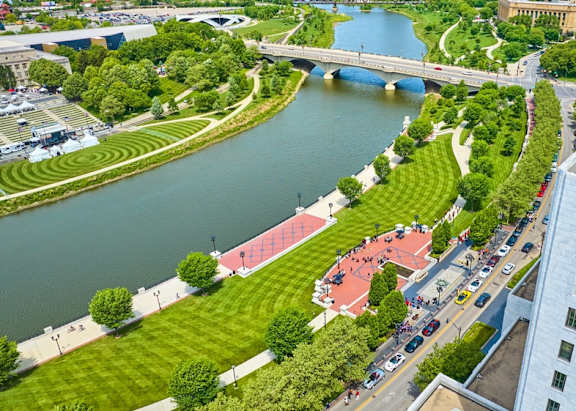A river flows through a city with a bridge crossing over it.